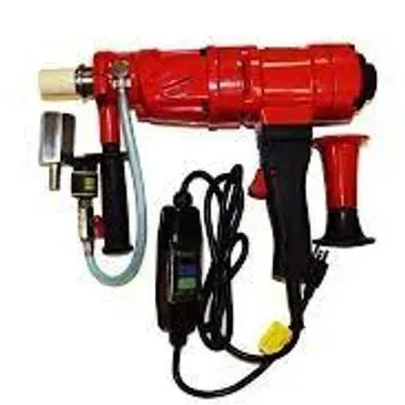 Red core drill with attached parts and black power cord.