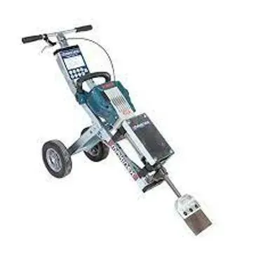 A floor scraper machine with a silver frame, blue motor, and large wheels.