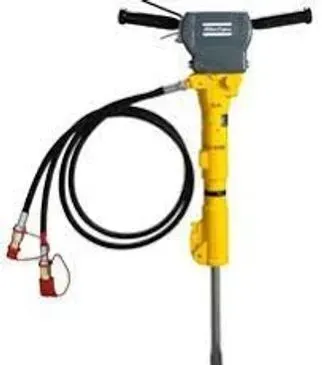 Yellow and grey pneumatic jackhammer with black hoses and handles.