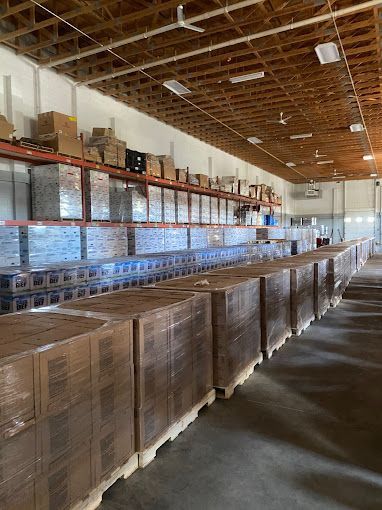 A large warehouse filled with lots of boxes and shelves.