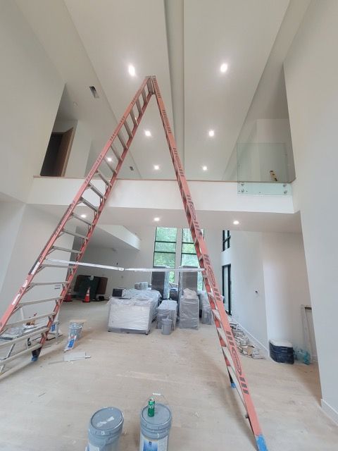 A large room with a ladder in the middle of it.