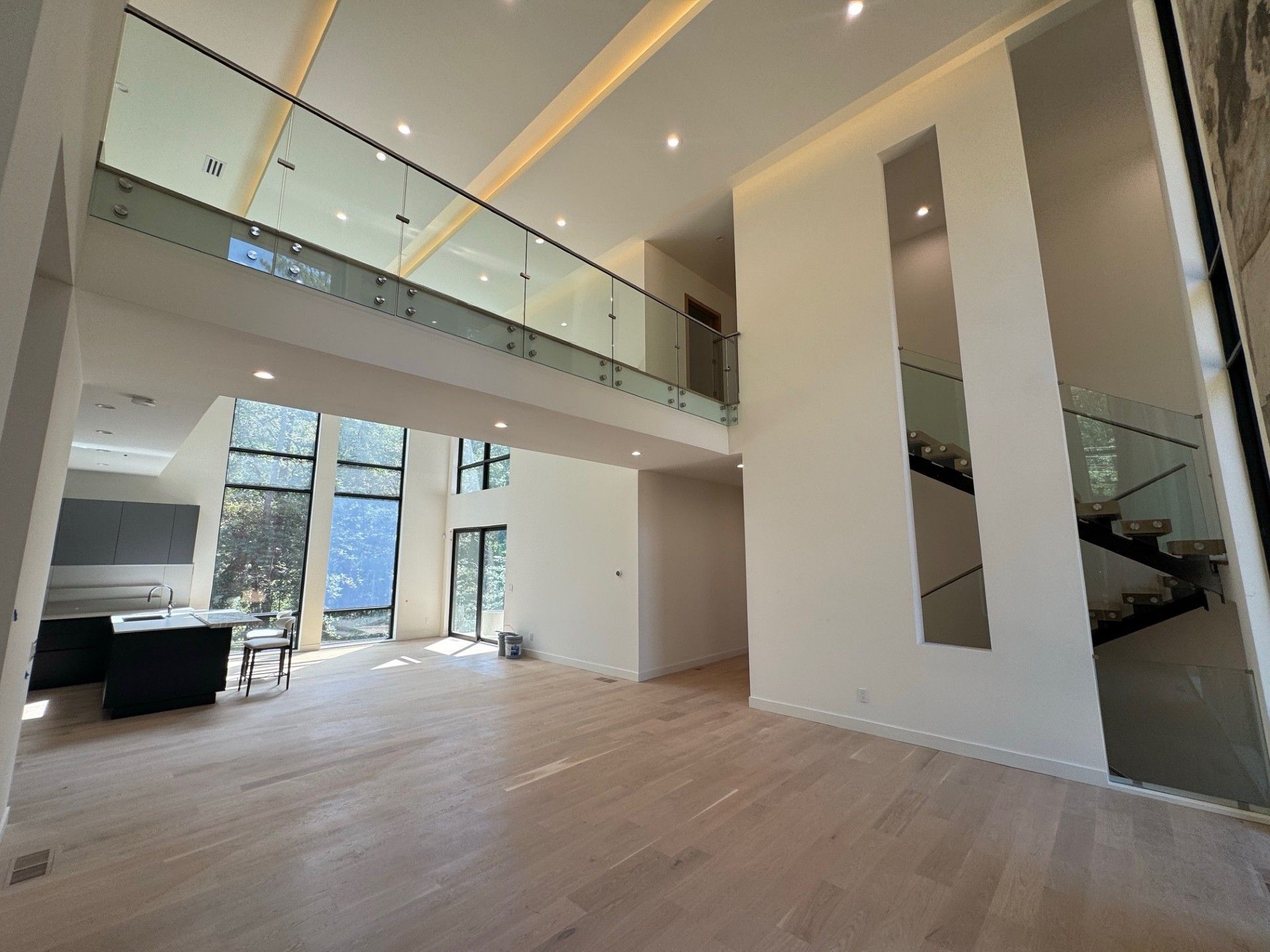 Modern, open-concept home interior with glass railing