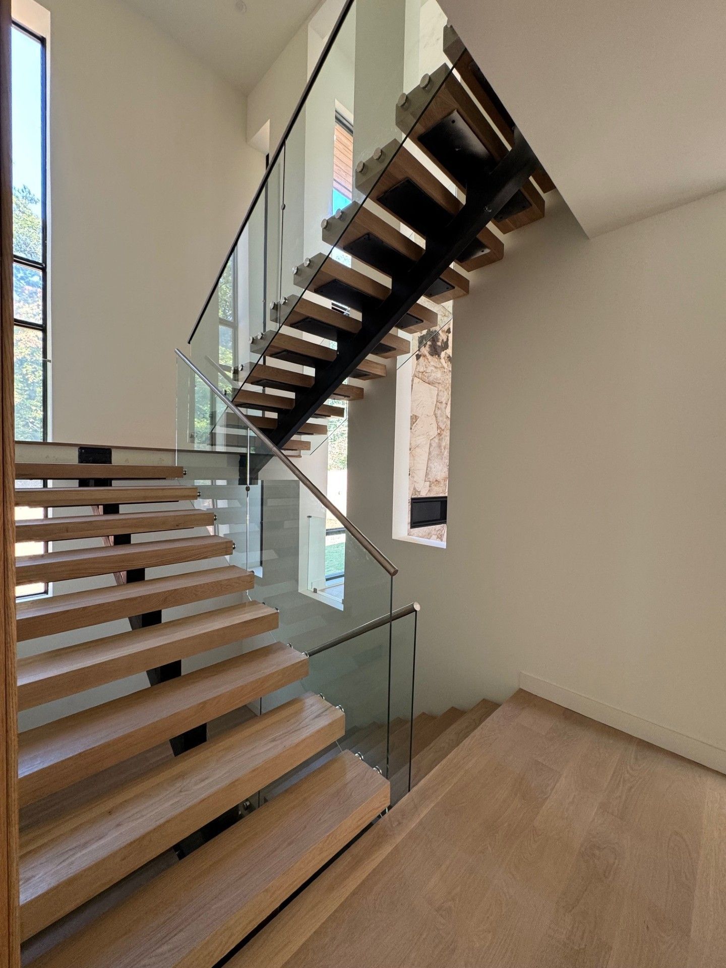 Modern wooden staircase with glass panels