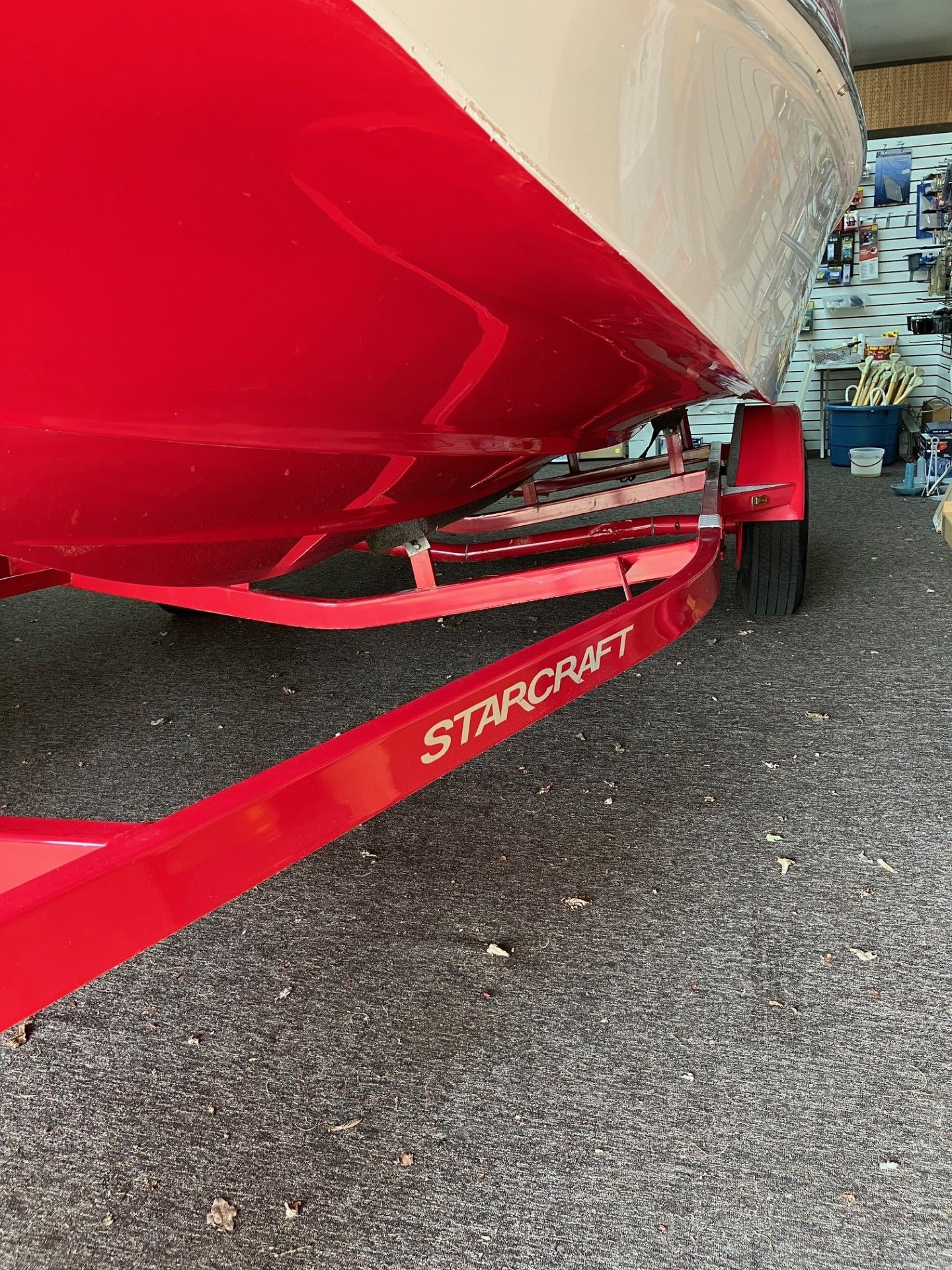 Red boat on a red Starcraft trailer at a marina dock.