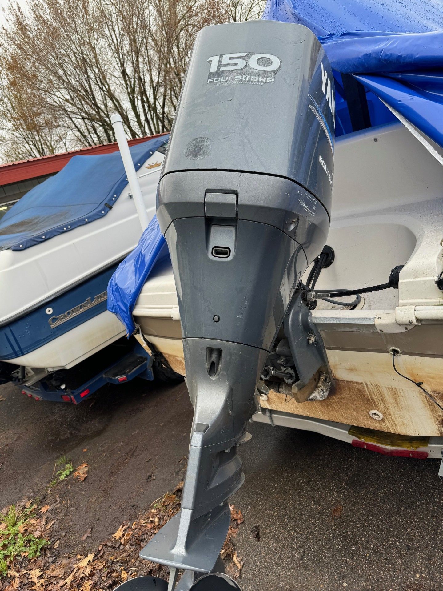 A yamaha 150 outboard motor is sitting on the side of a boat.