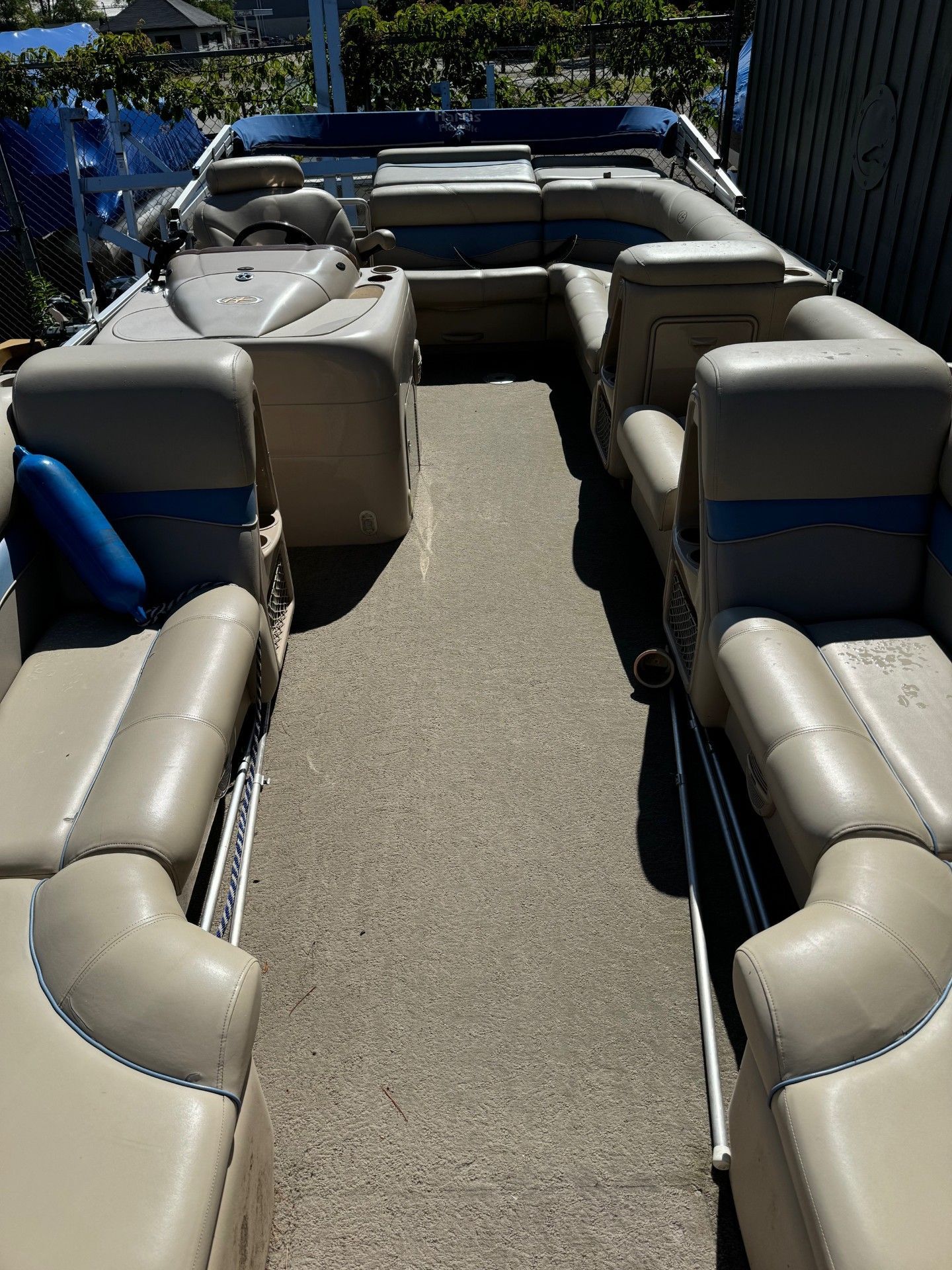 The inside of a pontoon boat with a lot of seats.