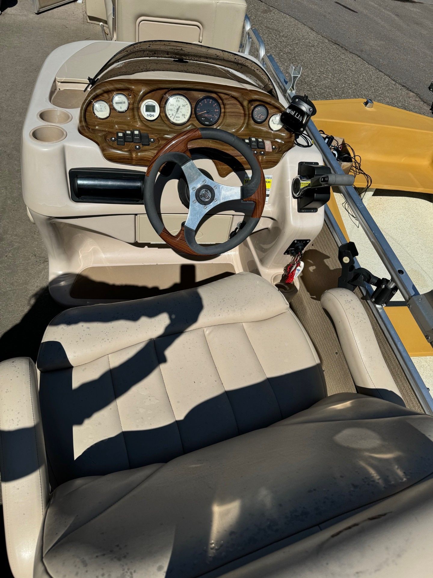 A boat with a steering wheel and a seat