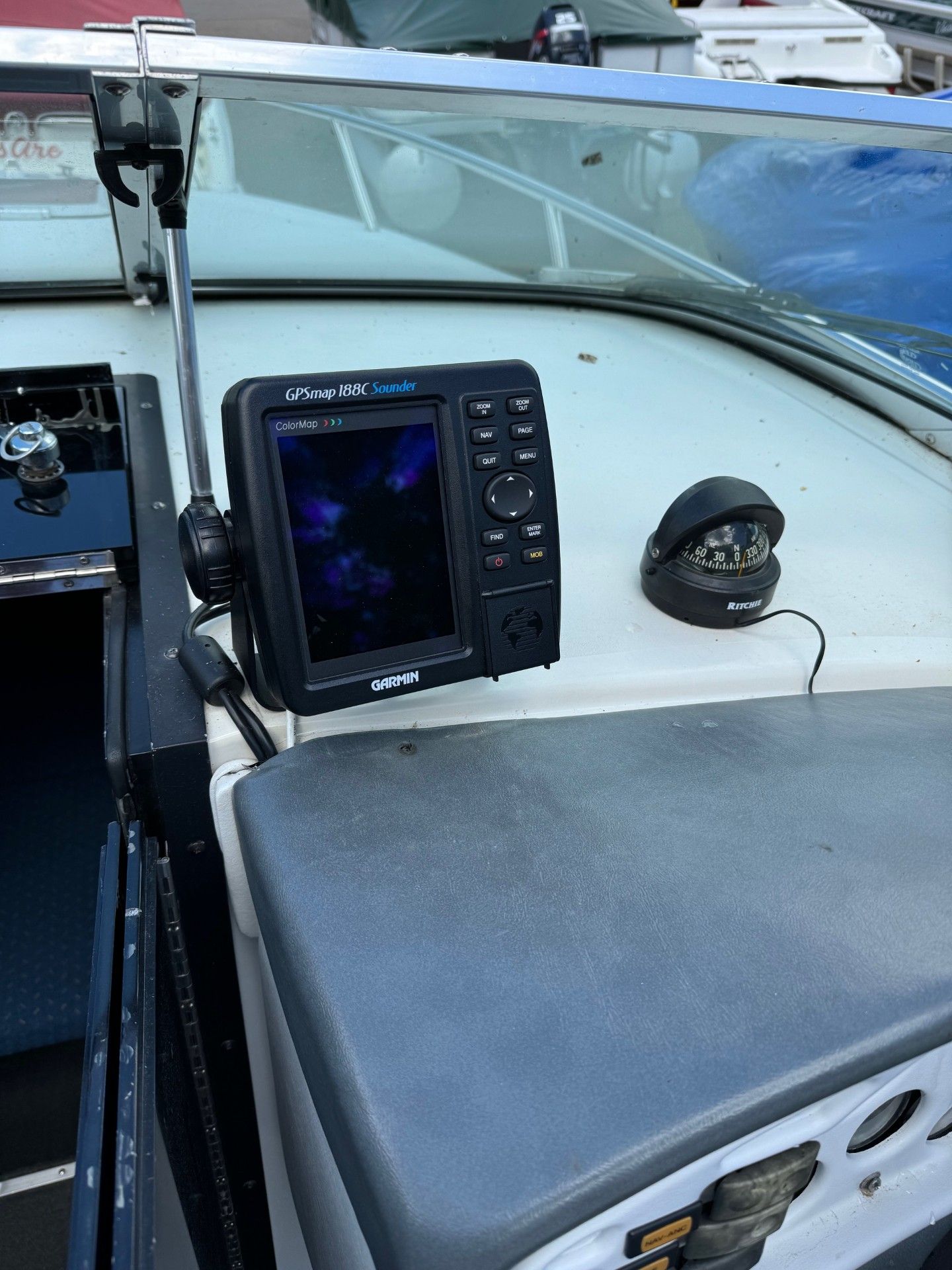 A boat with a GPS and compass on the dashboard