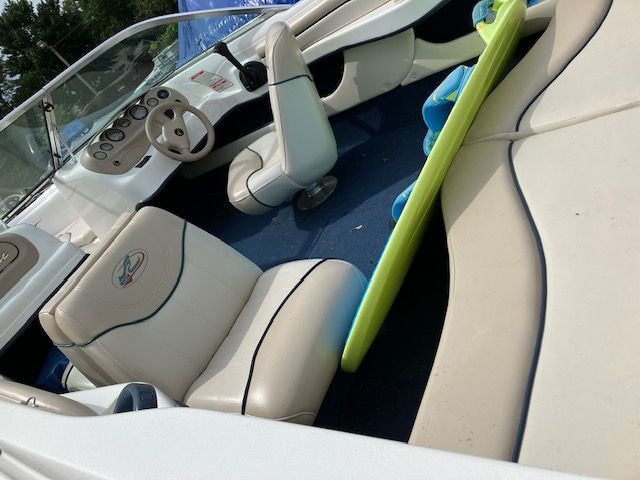 A white boat with a steering wheel and seats