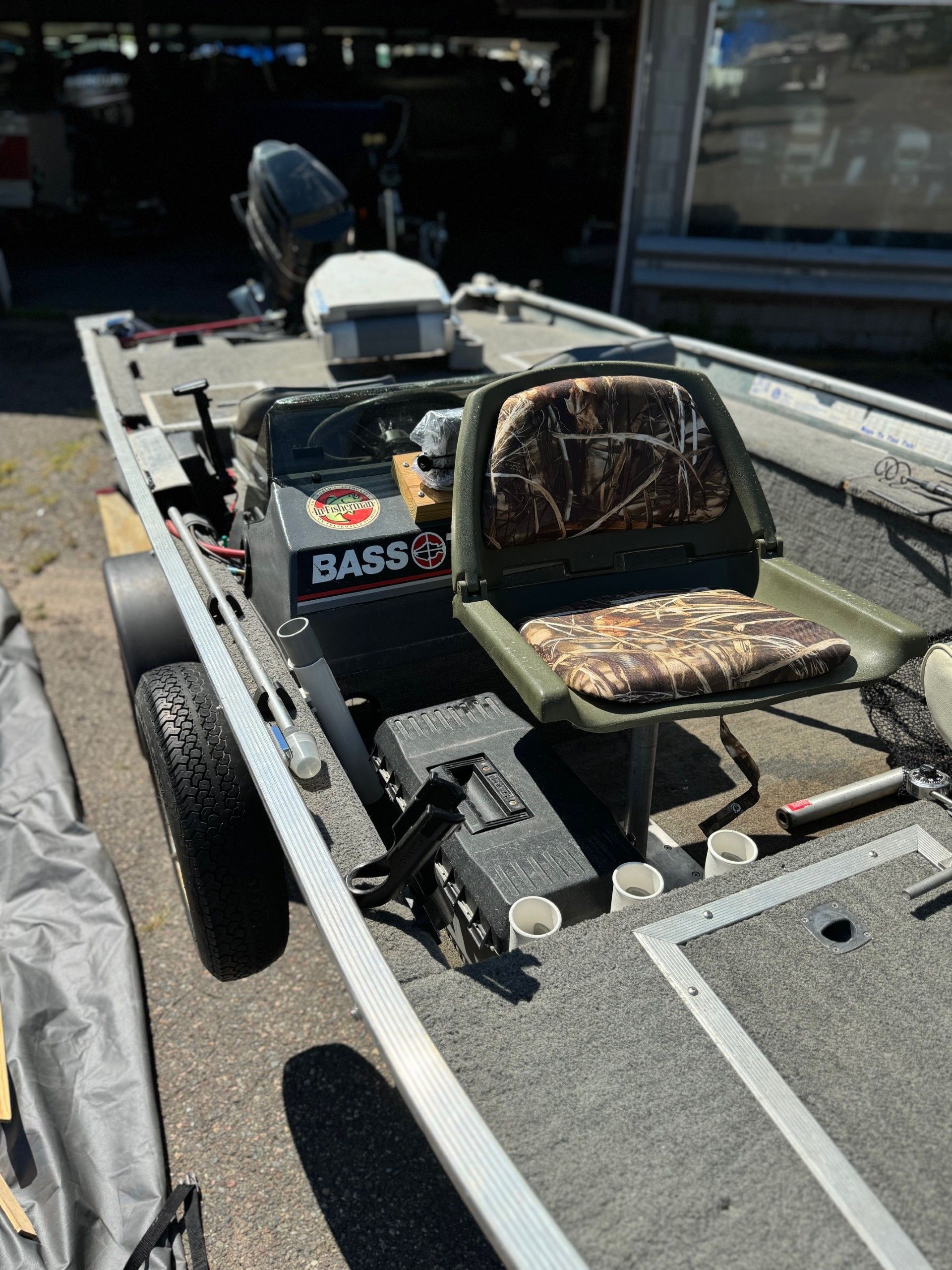 A fishing boat is parked on the side of the road.