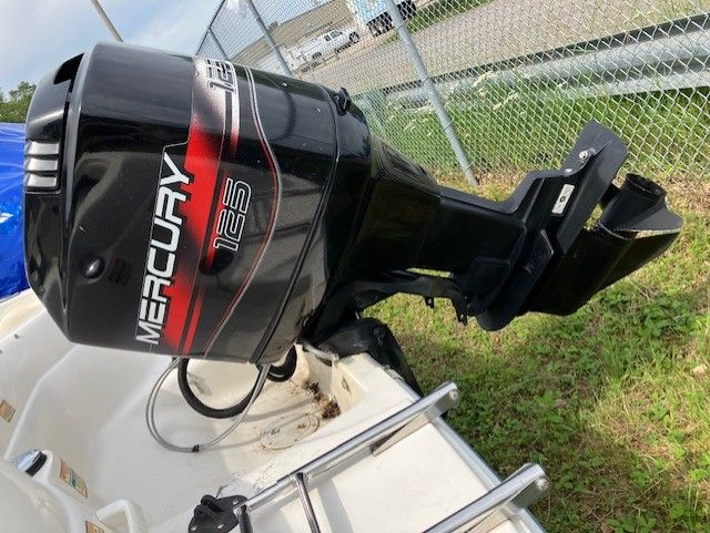 A mercury outboard motor is sitting on top of a boat