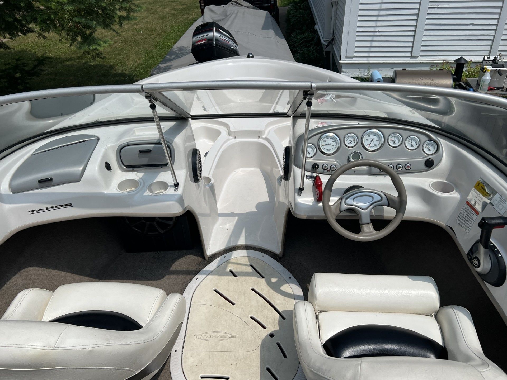 the inside of a boat with a steering wheel and dashboard