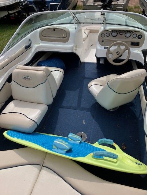 The inside of a boat with a surfboard on the floor