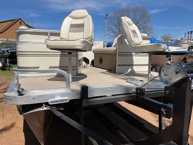 A pontoon boat is sitting on top of a trailer