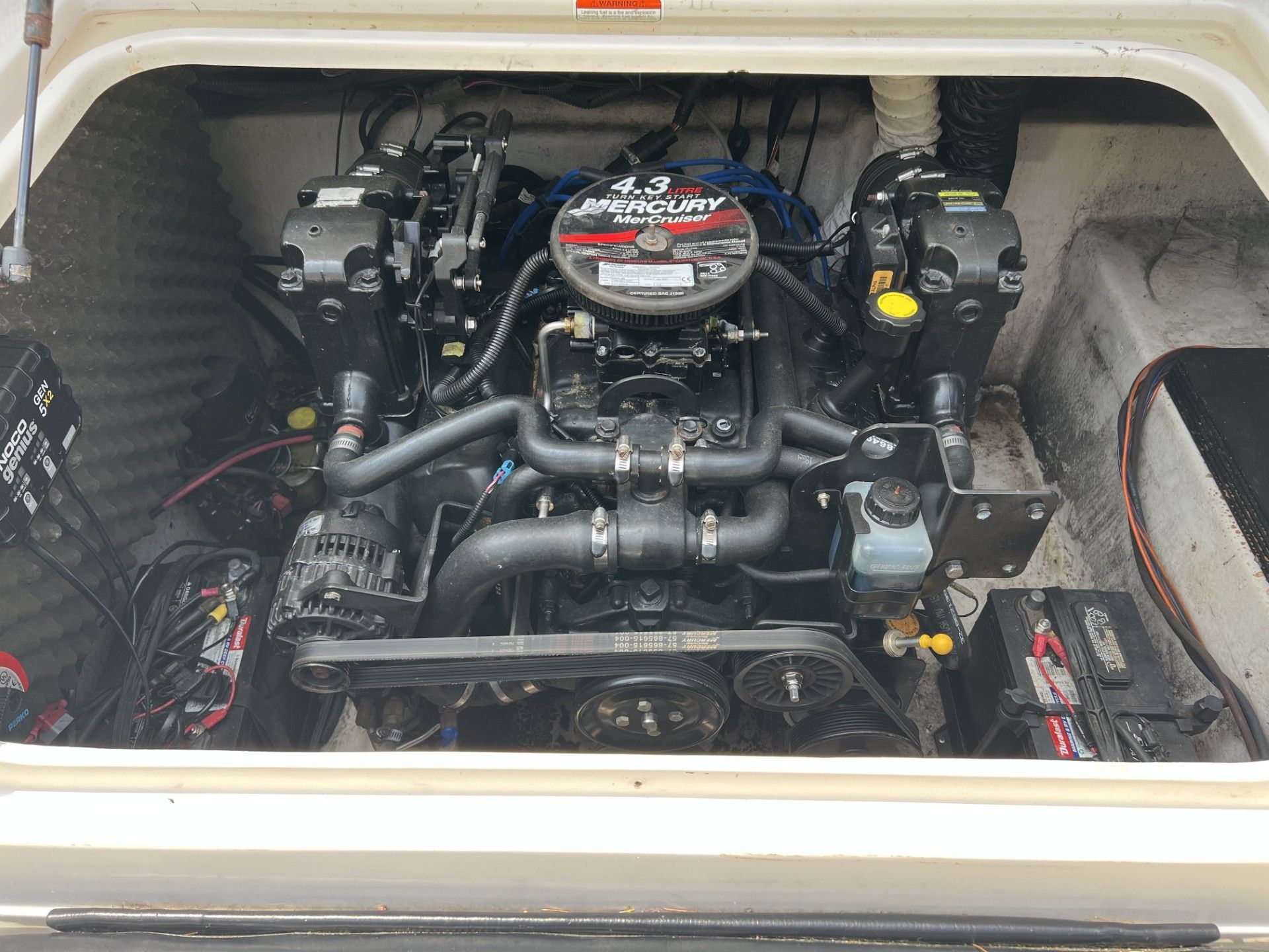 a mercury engine is sitting in the trunk of a boat