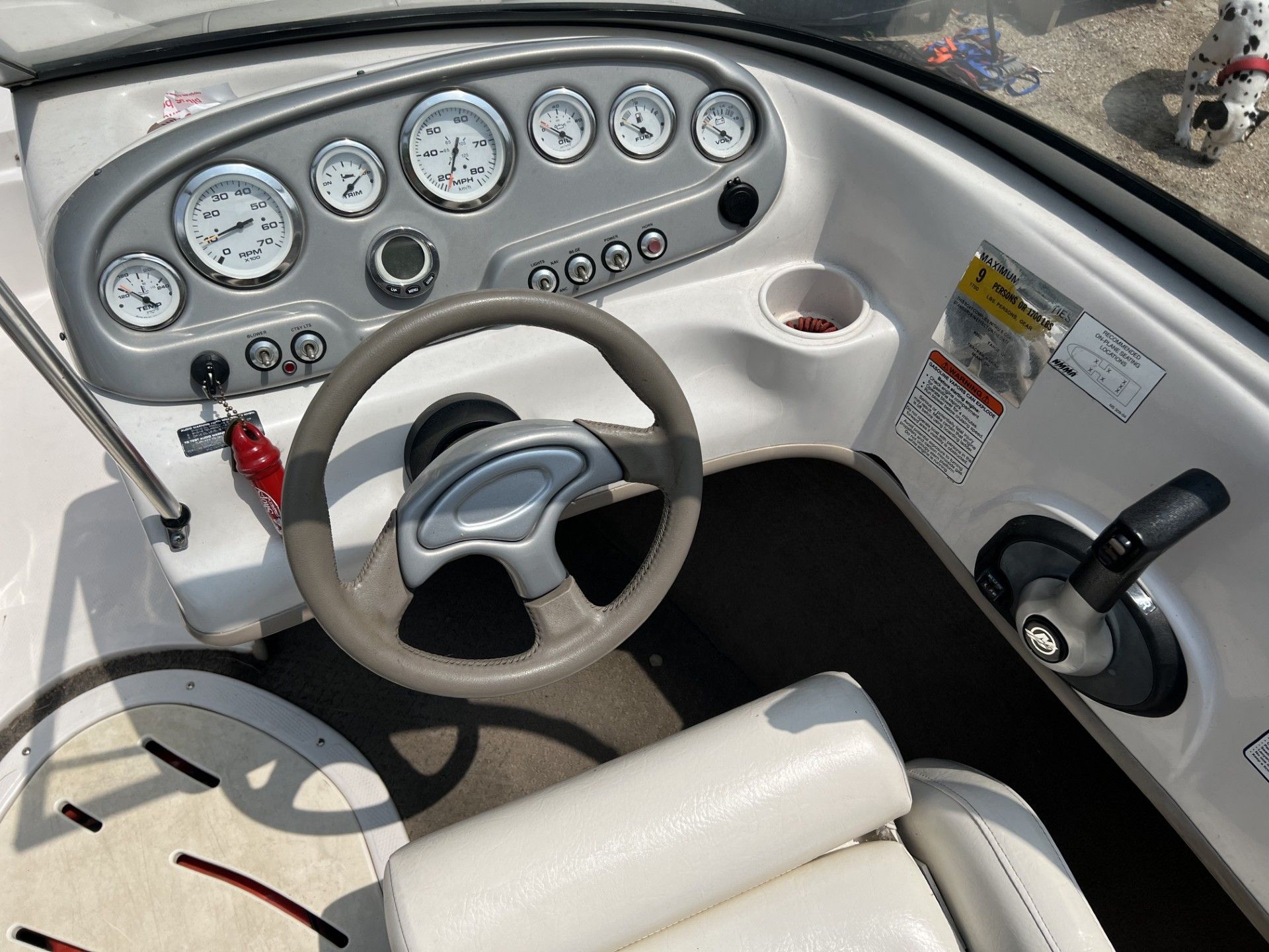 a boat with a steering wheel and a lot of gauges on it