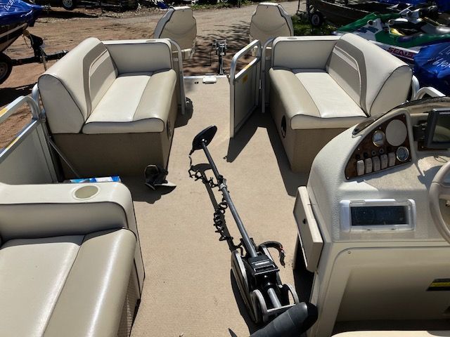 The inside of a pontoon boat with a motor attached to it