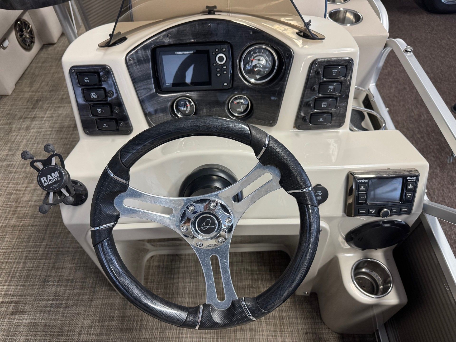 A boat with a steering wheel and controls on it