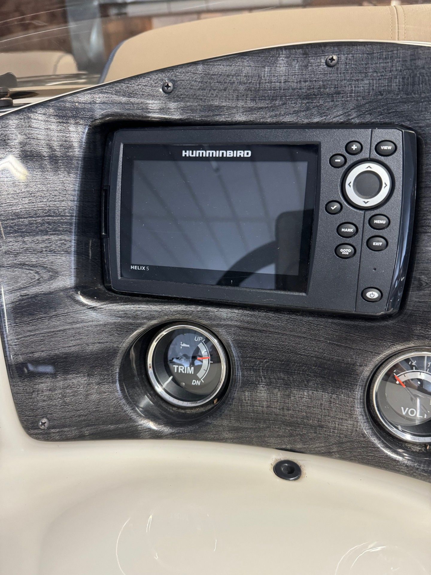 A dashboard of a boat with a gps on it.