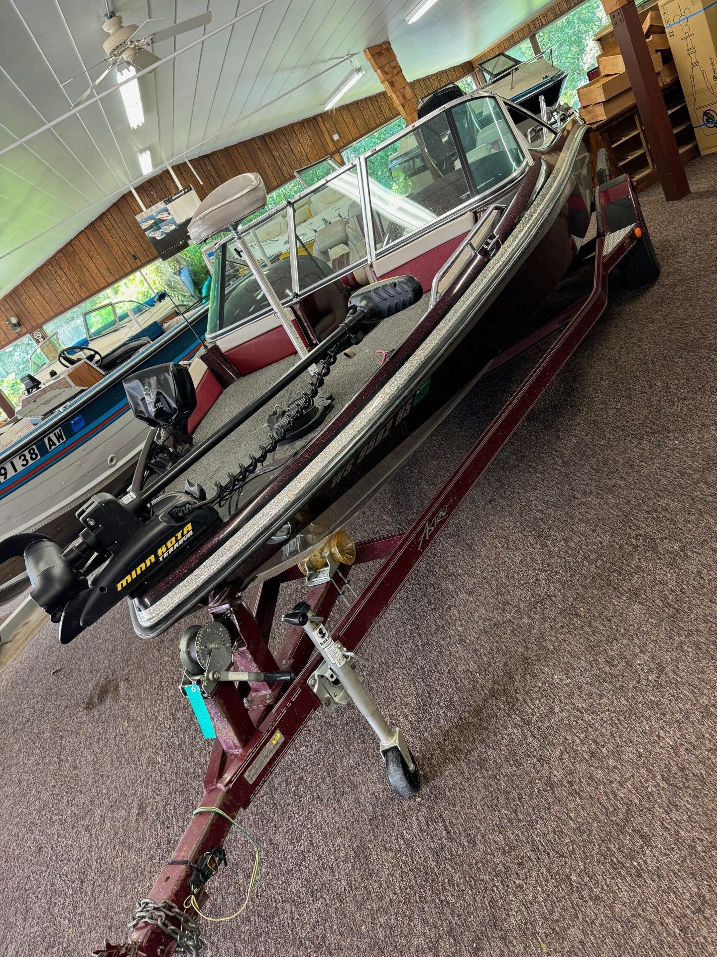 A fishing boat is sitting on a trailer in a showroom