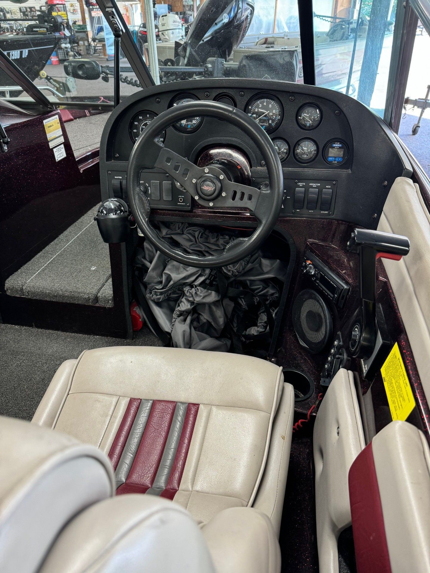 The interior of a boat with a steering wheel and seats