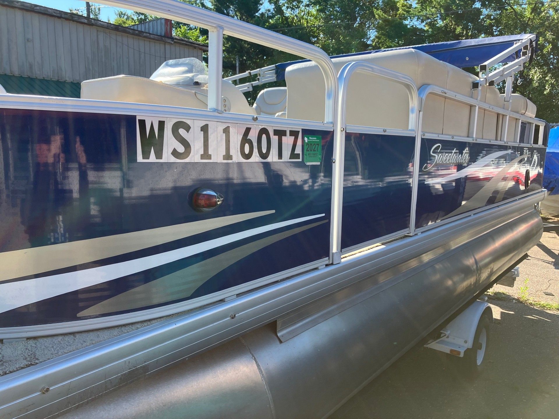 Blue and silver pontoon boat with 