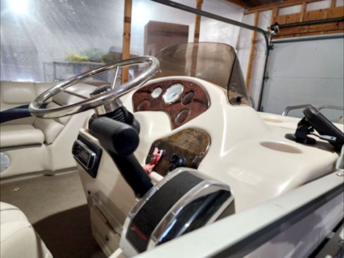 The inside of a boat with a steering wheel