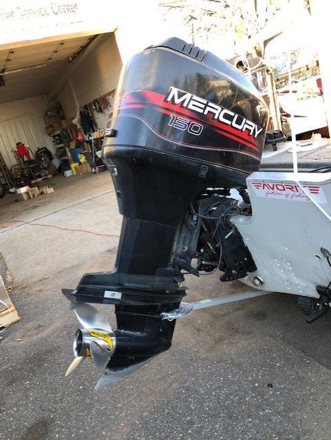 A mercury outboard motor is sitting on top of a boat
