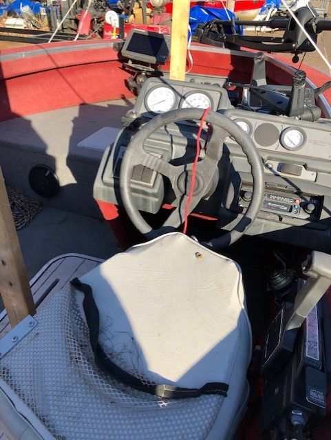 A boat with a broken seat and steering wheel