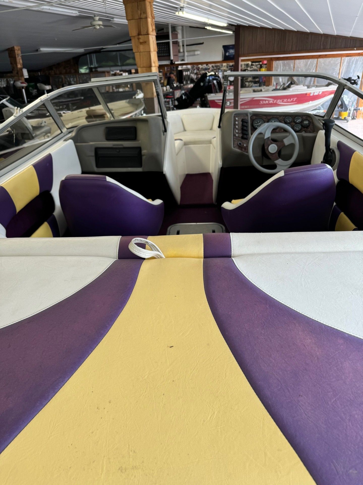 The inside of a boat with purple and yellow seats