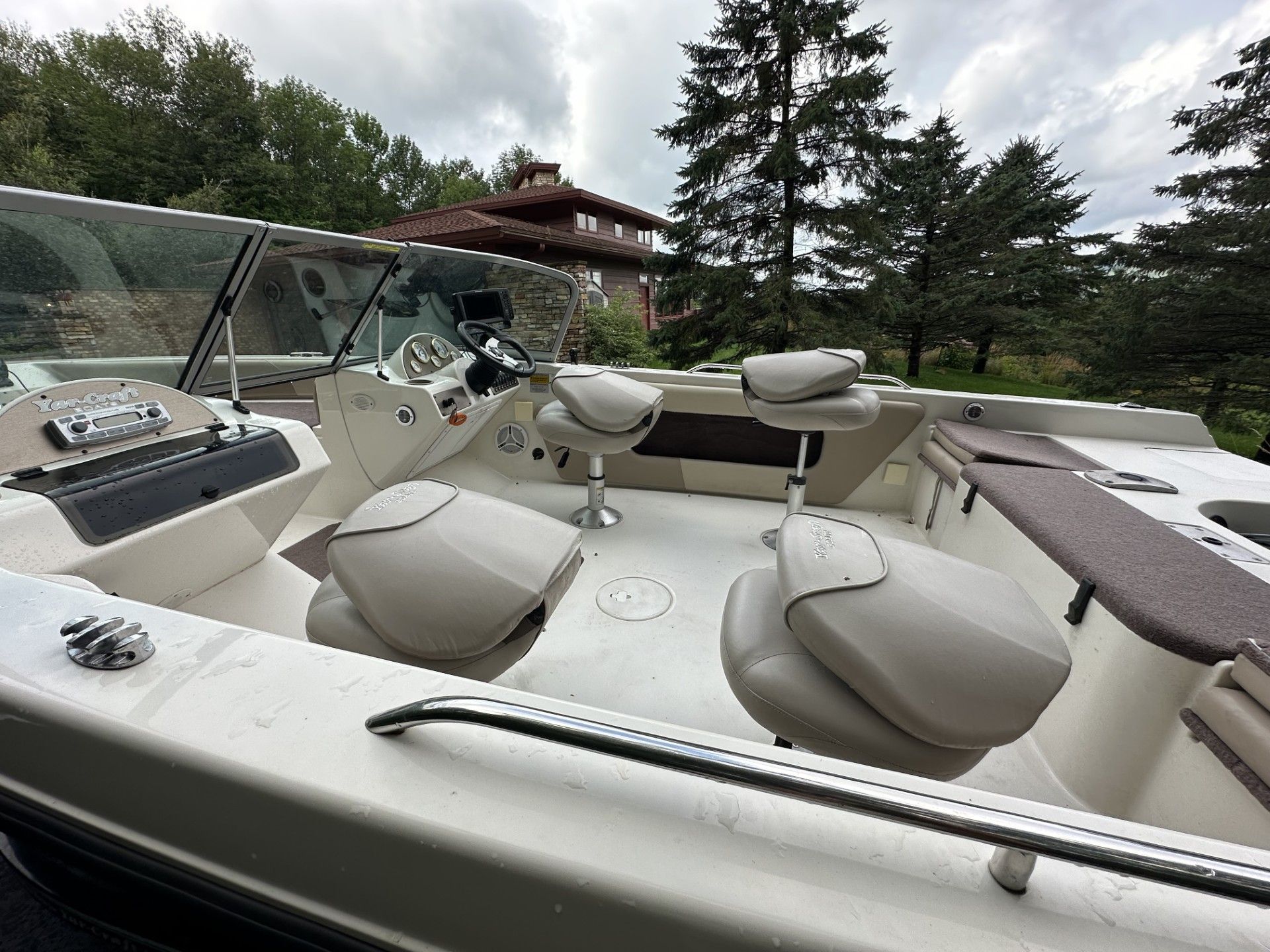 A boat with a lot of seats and a steering wheel.