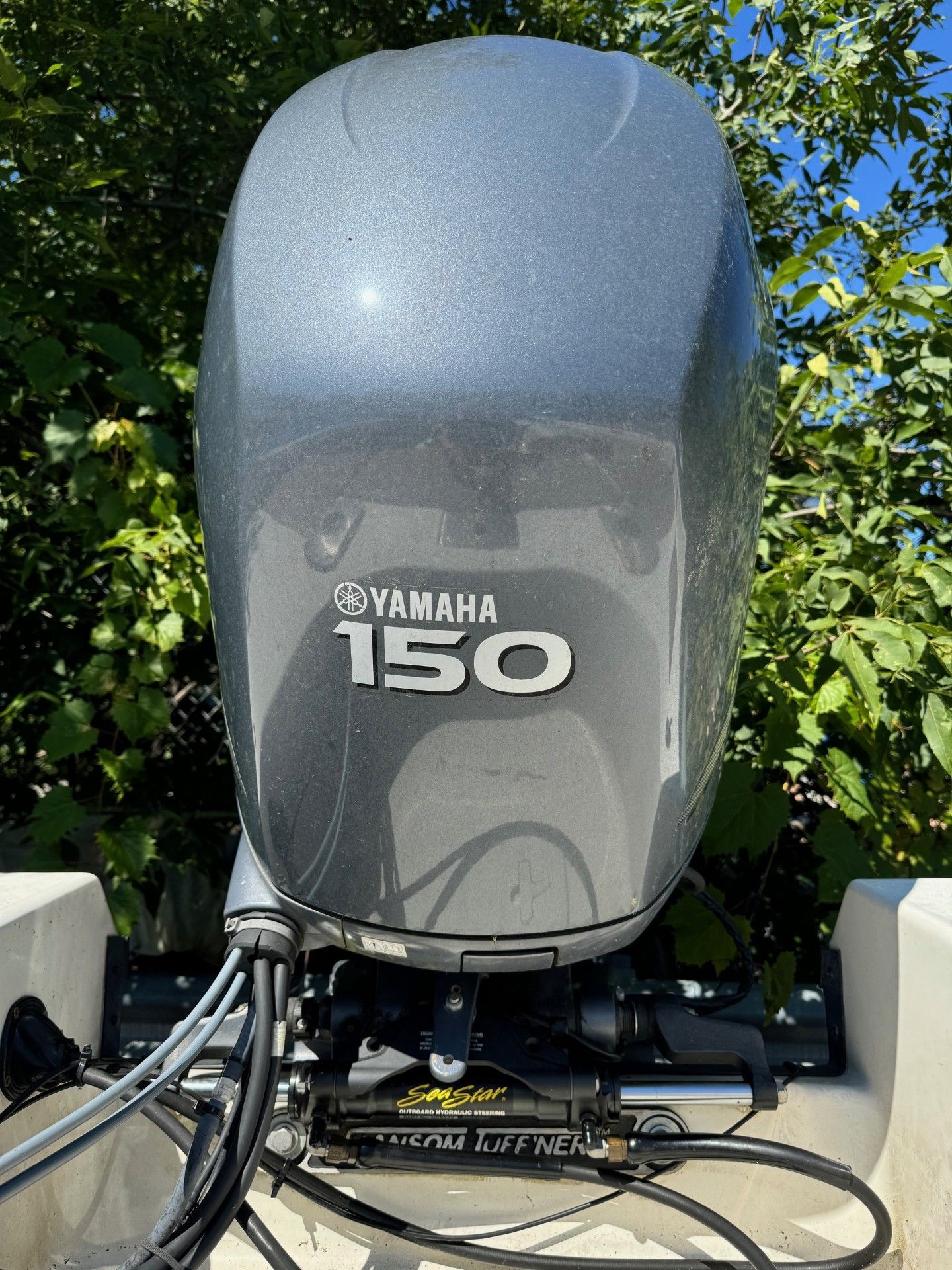 A yamaha 150 outboard motor is sitting on top of a boat.