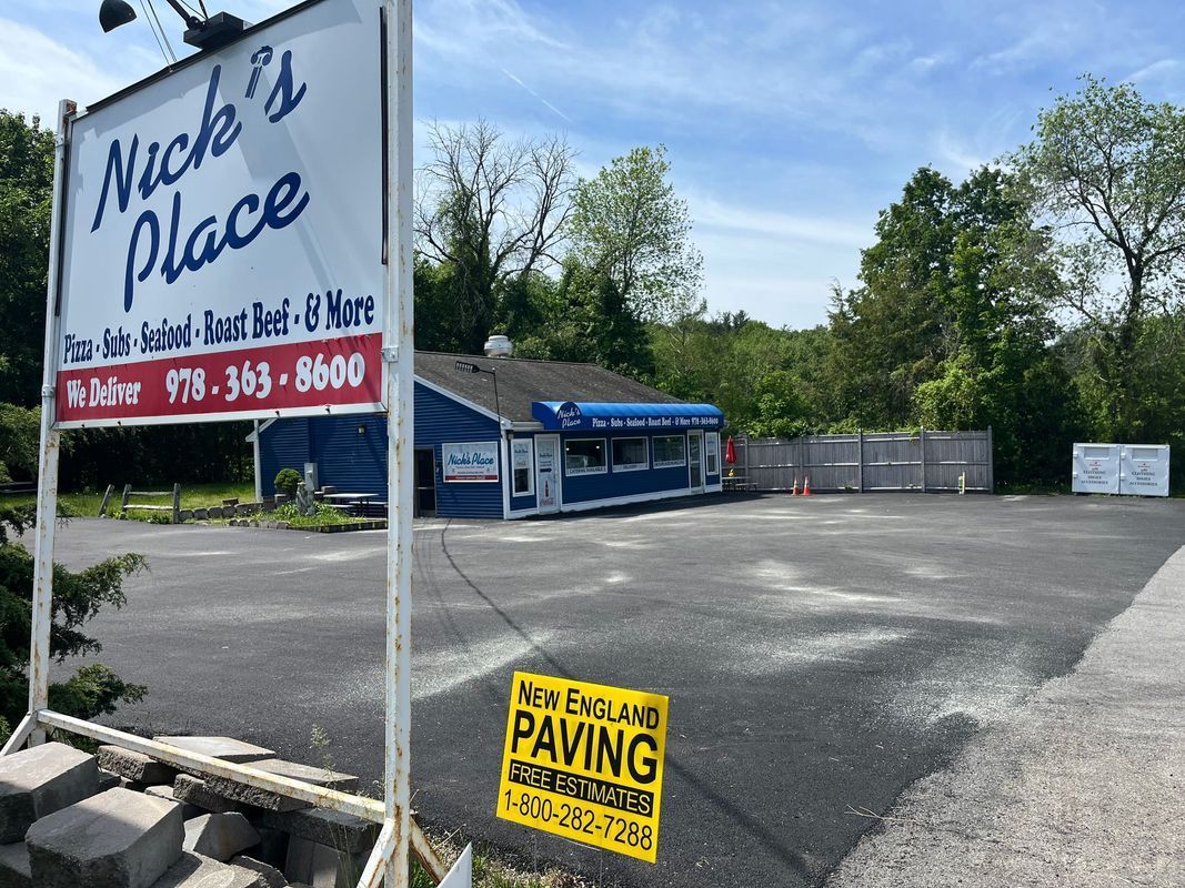 Nick's Place restaurant with new asphalt parking lot. Sign says 