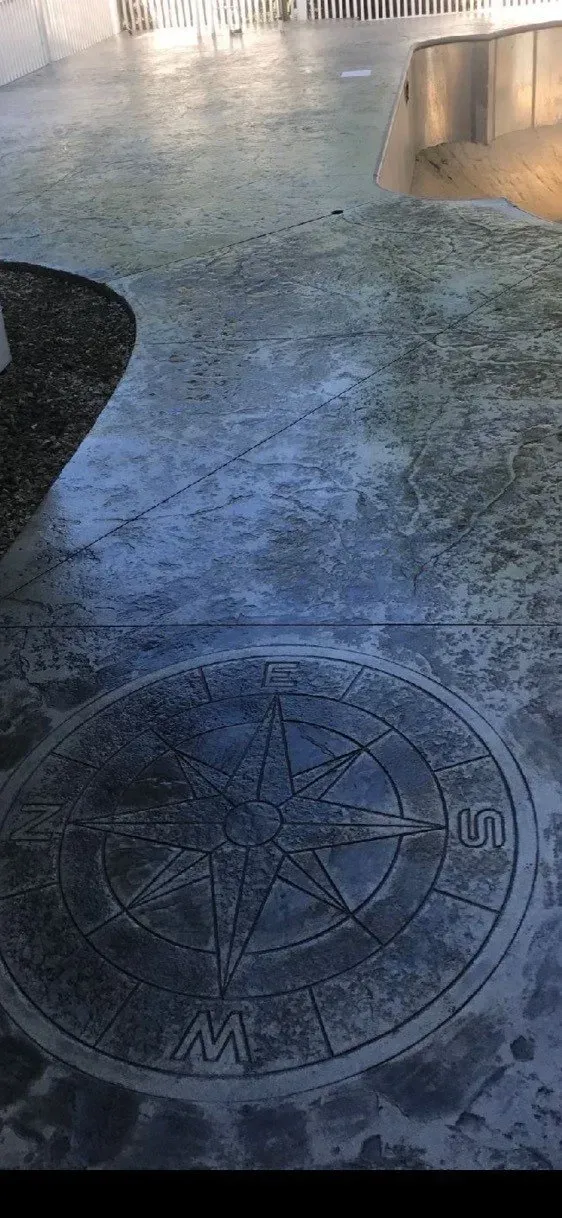 Wet stone pavement with a circular compass-like mosaic in the foreground