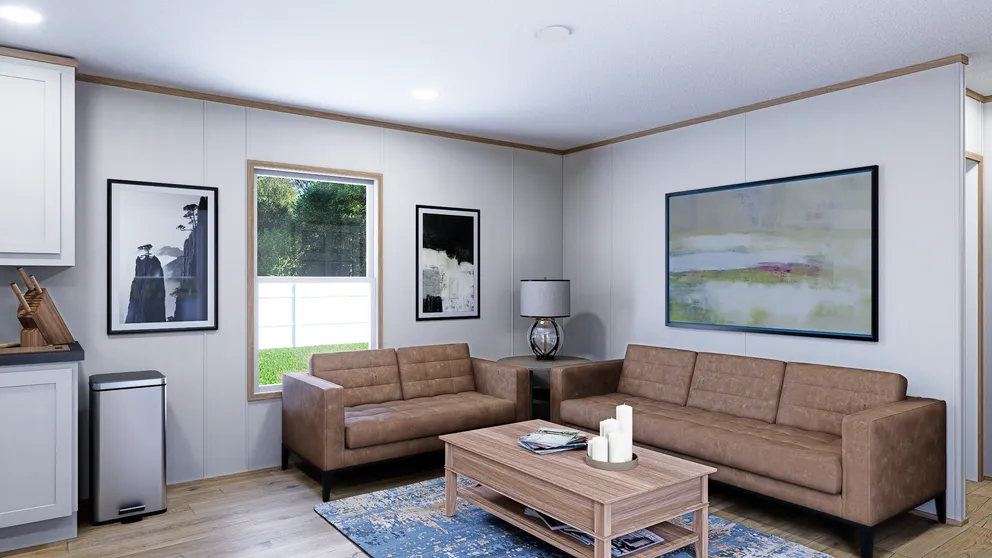 Living room with two brown sofas, wooden coffee table, art, and a window.