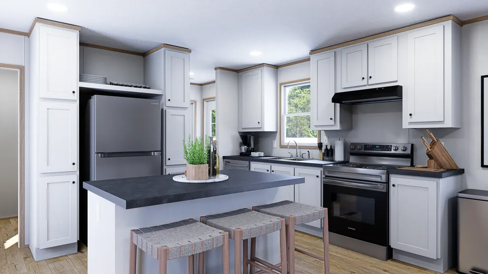 Modern kitchen with white cabinets, dark countertops, and stainless steel appliances.