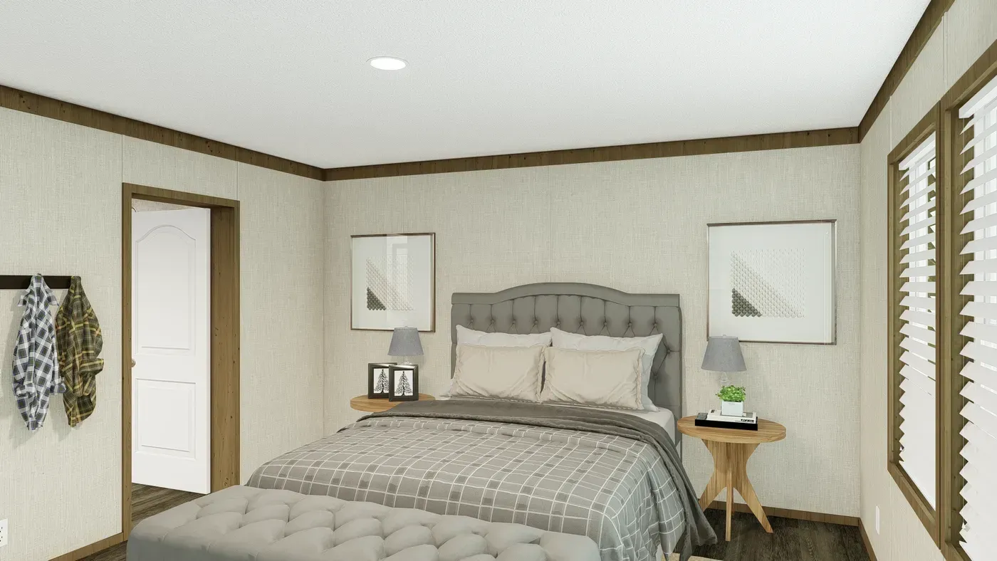 Bedroom with gray tufted headboard, two nightstands, artwork, and a bench at the foot of the bed.