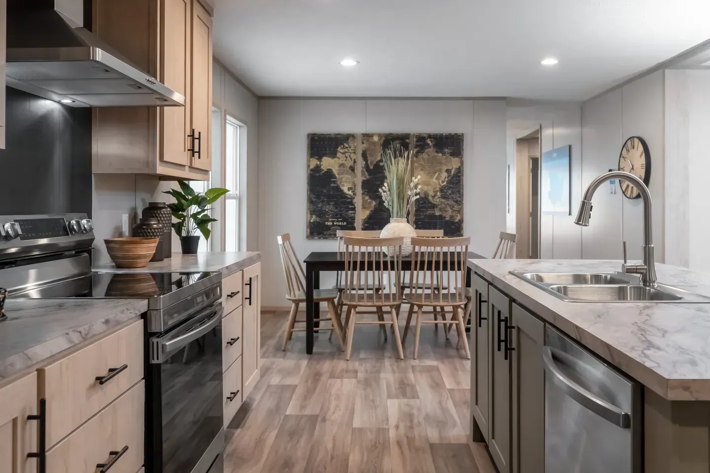 Kitchen interior with wooden cabinets, dining table, and stainless steel appliances.