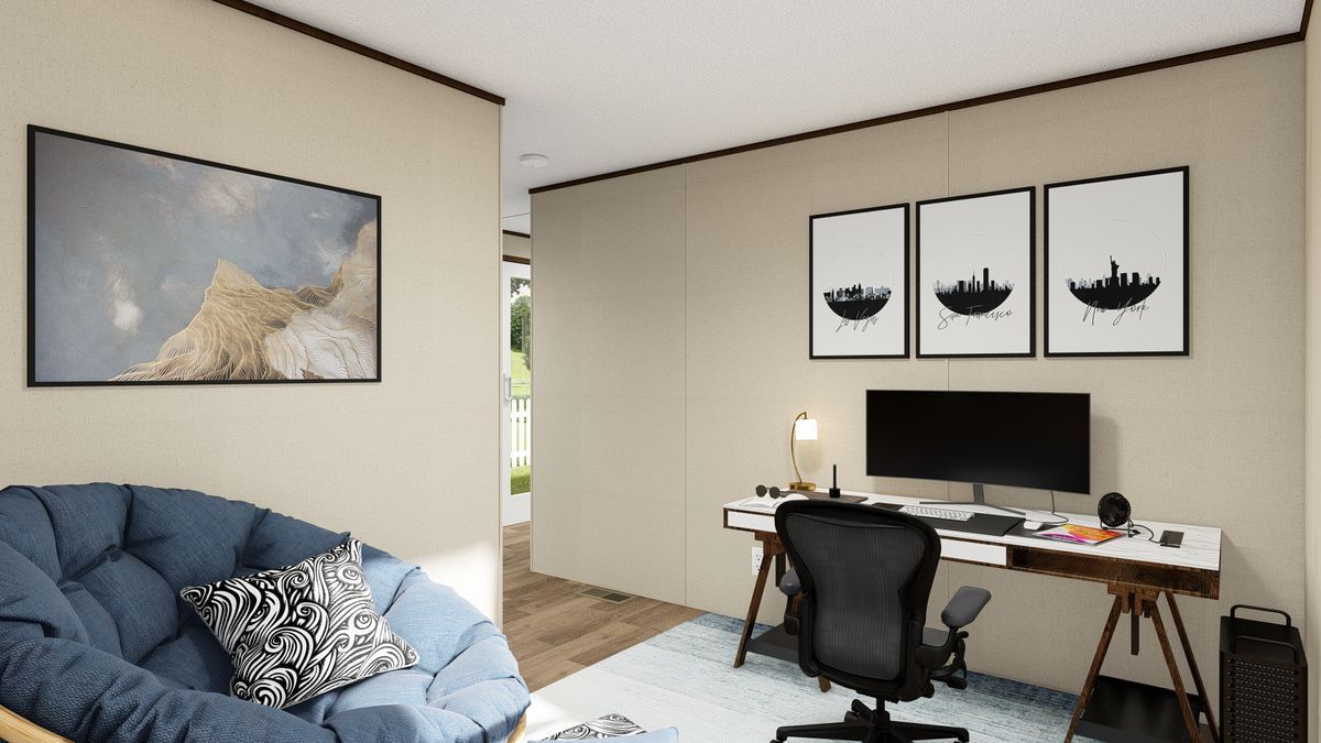 Home office with desk, art, blue chair, rug, and open doorway.