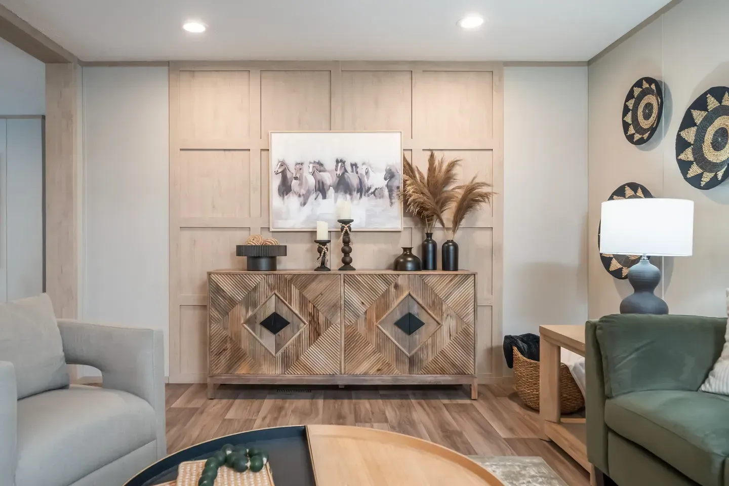 Living room with a carved wood buffet, artwork, and decorative wall hangings.