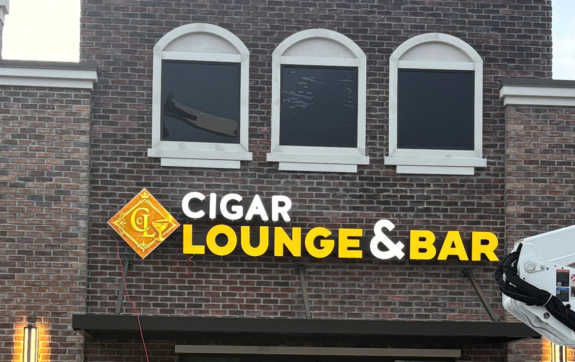Cigar Lounge & Bar sign on a brick building