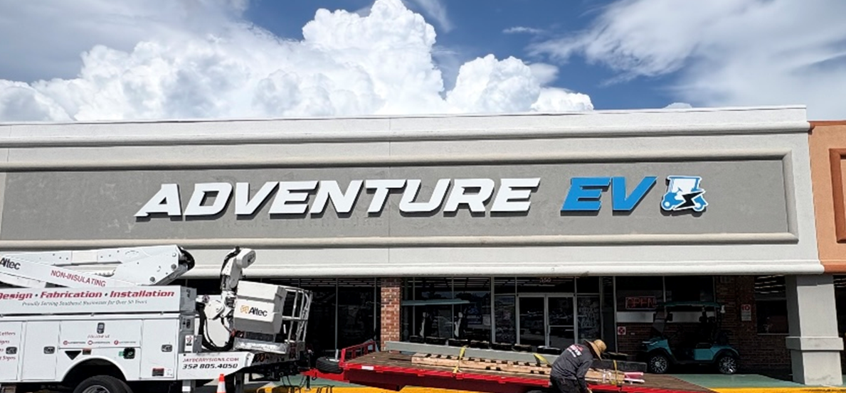 Adventure EV storefront sign