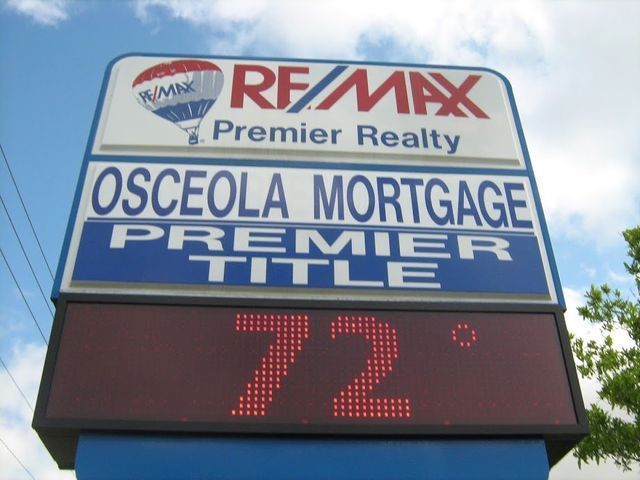 Sign for RE/MAX, Osceola Mortgage, and Premier Title. Electronic display shows 72 degrees.