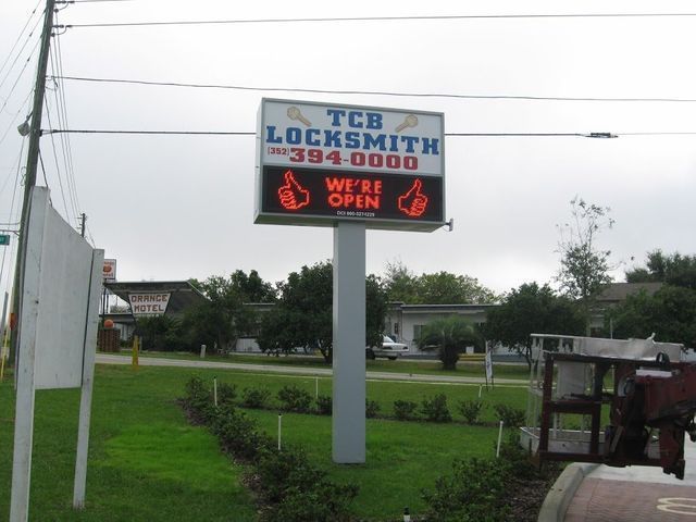 Sign for TCB Locksmith, phone number included. 