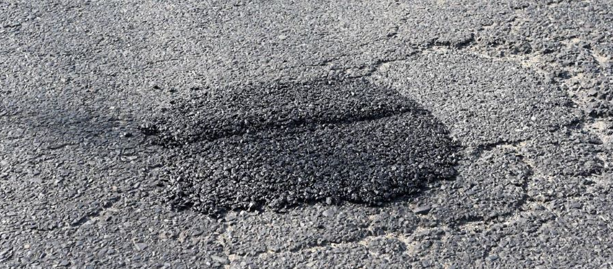 A black and white photo of a hole in the ground.