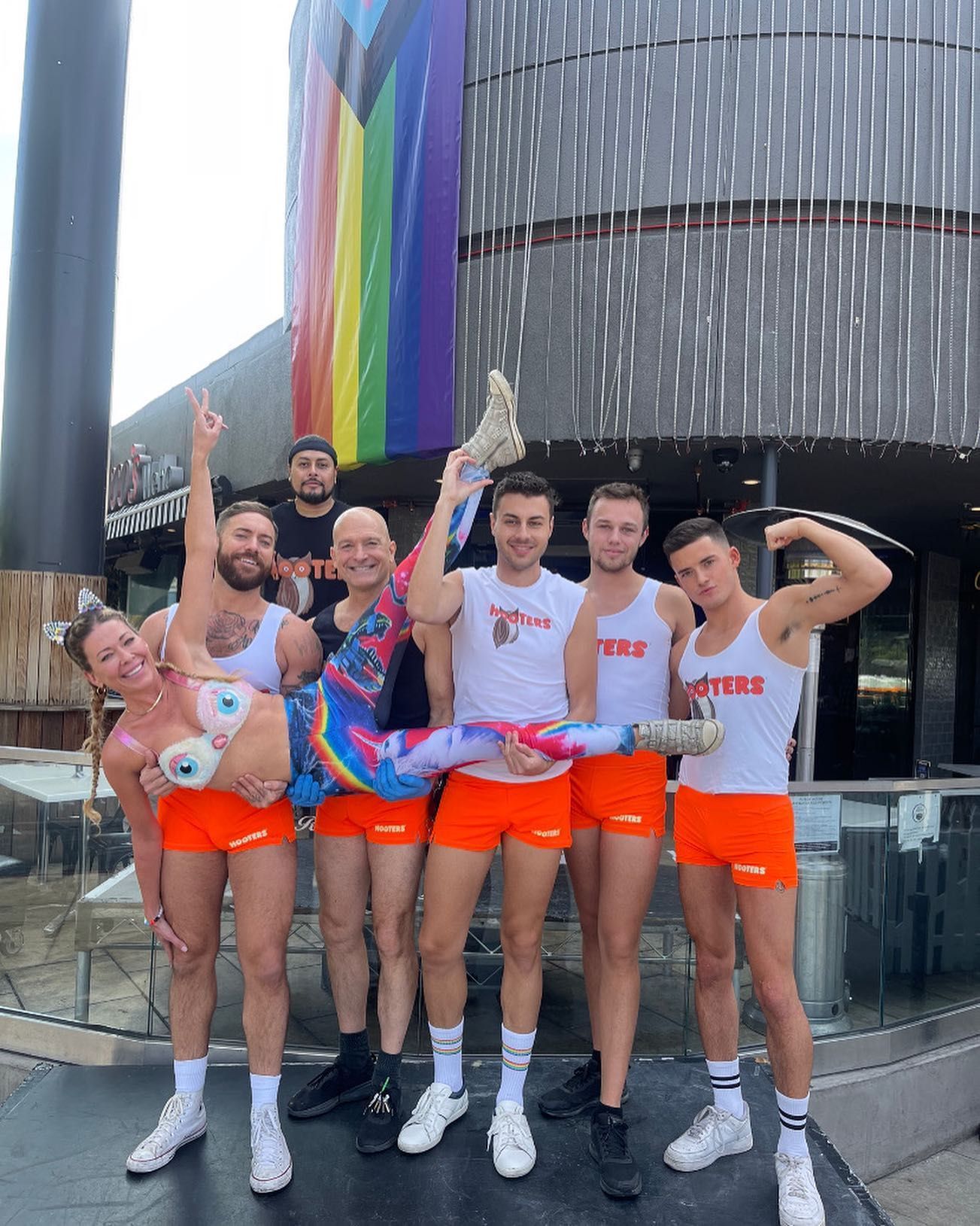 A group of people are posing for a picture in front of a building.