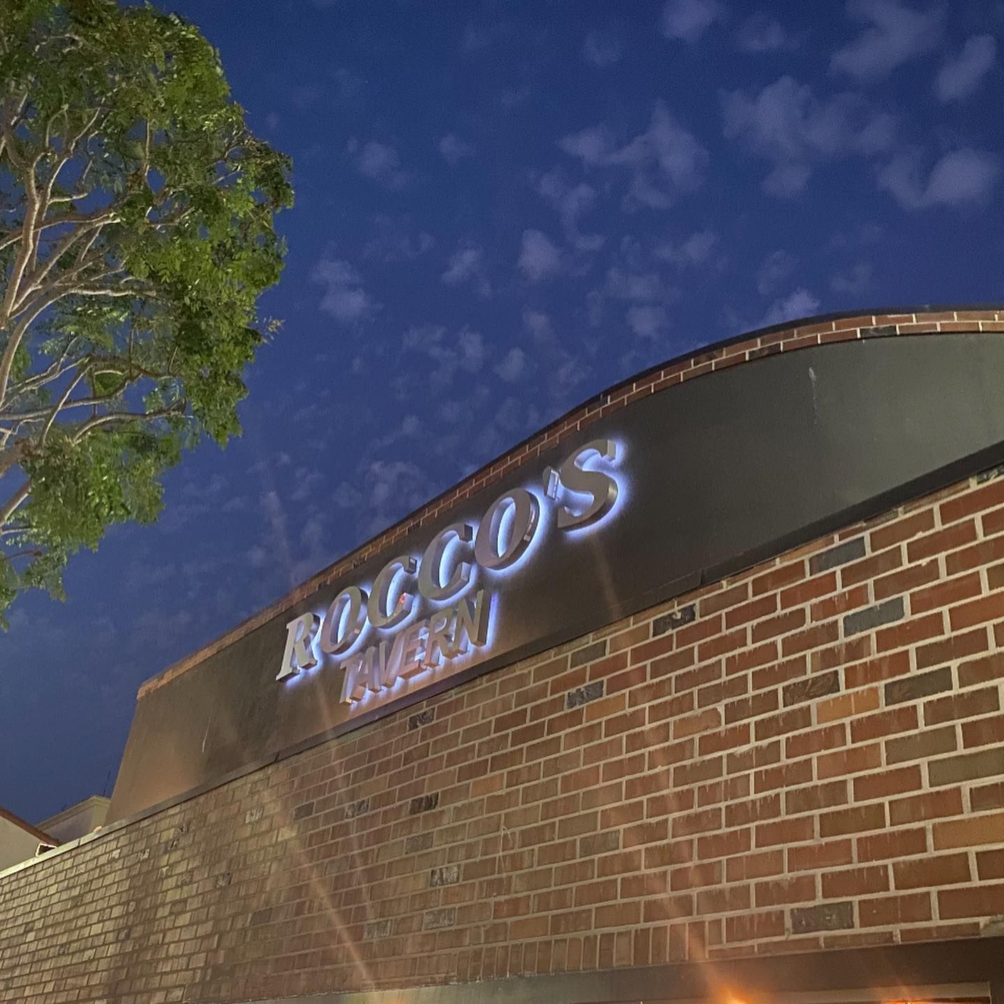 A brick building with a sign that says rocco 's