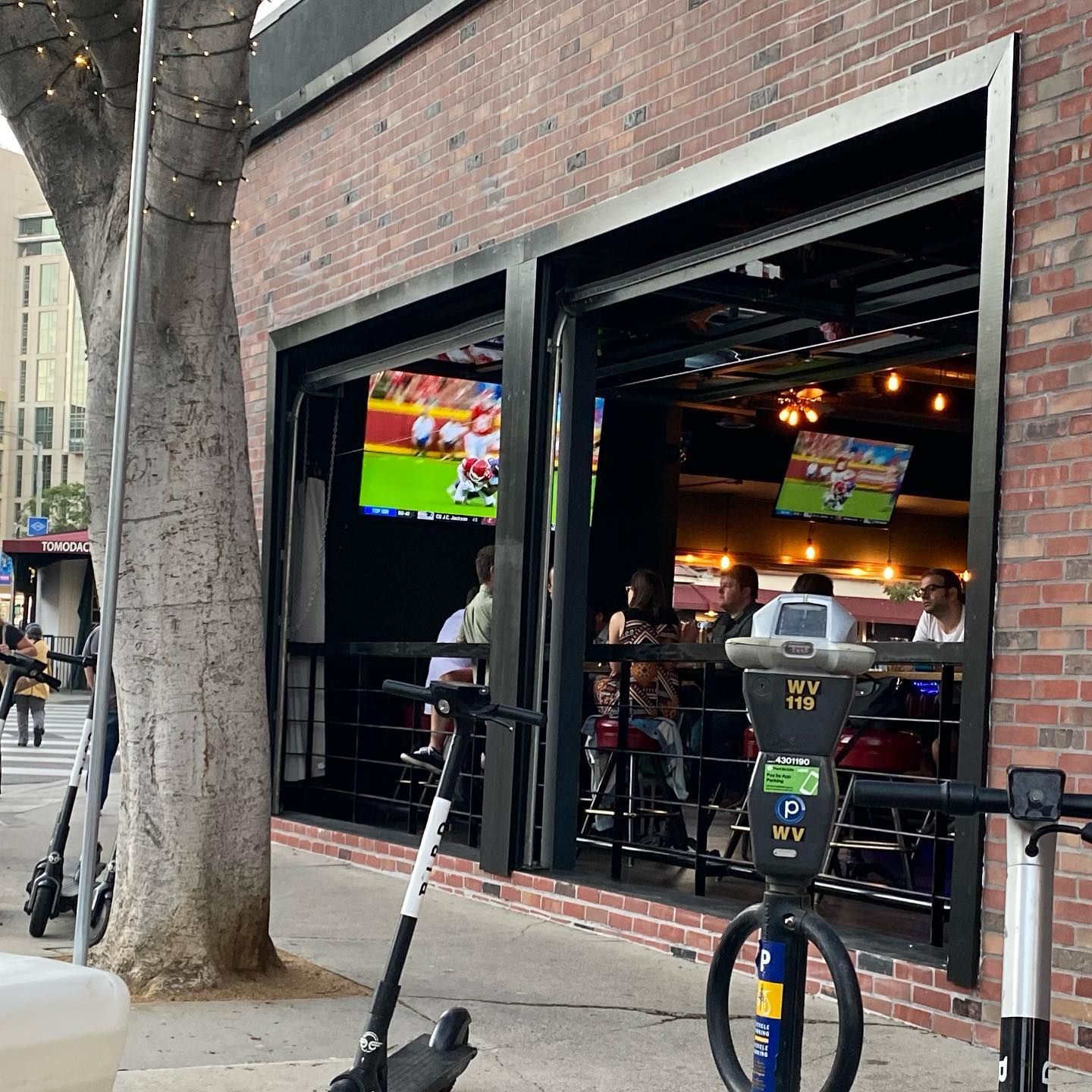 A scooter is parked in front of a brick building