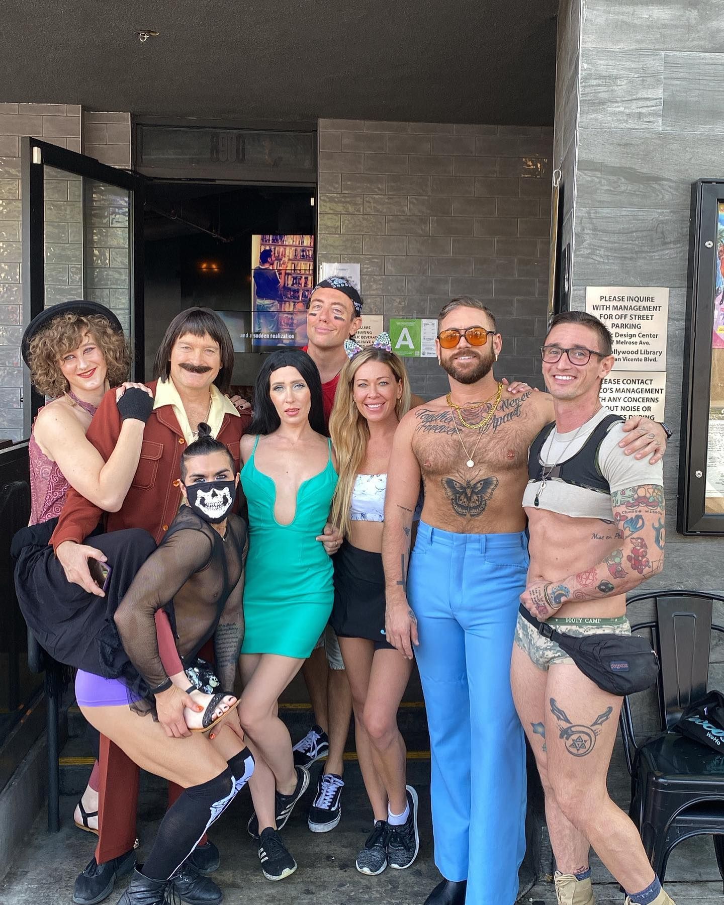 A group of people are posing for a picture in front of a building.