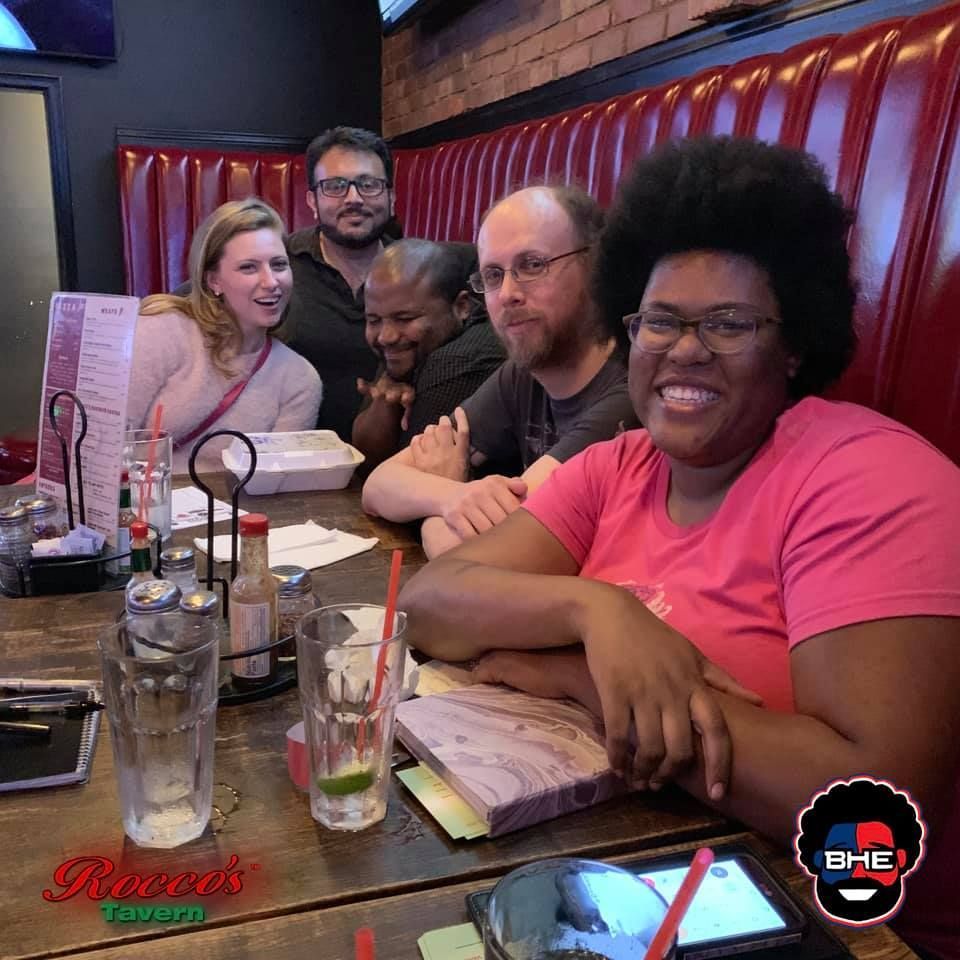 A group of people are sitting at a table in a restaurant.
